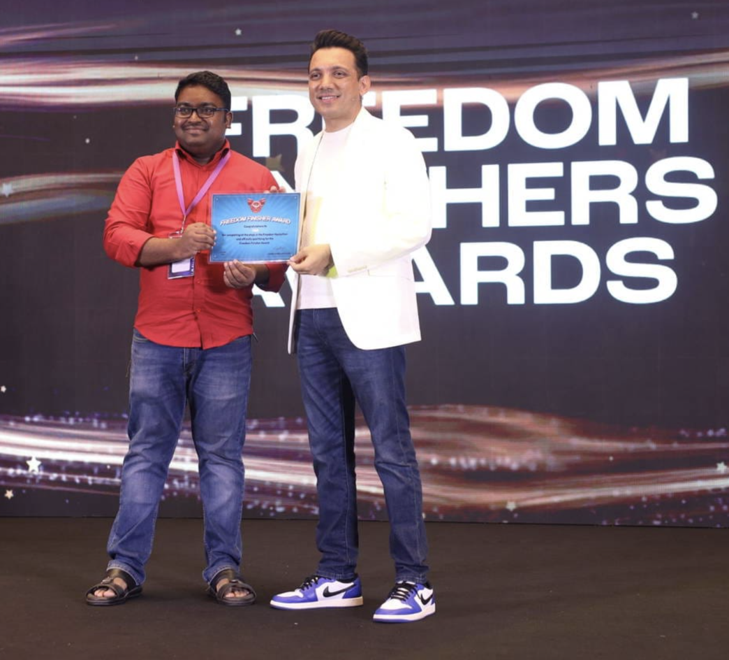 Vibil Raj receiving the Freedom Finisher Award on stage